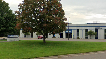 Dedicated white and blue building with tree